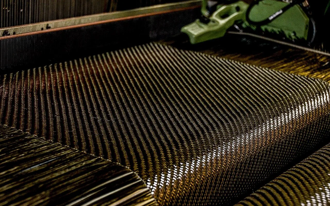 Carbon-fibre fabric on a weaving loom.